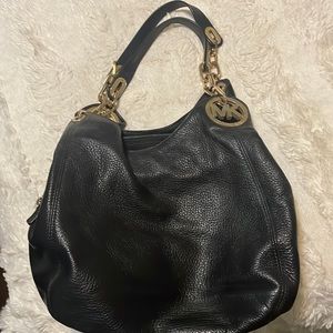 Black Michael Kors purse with gold accents